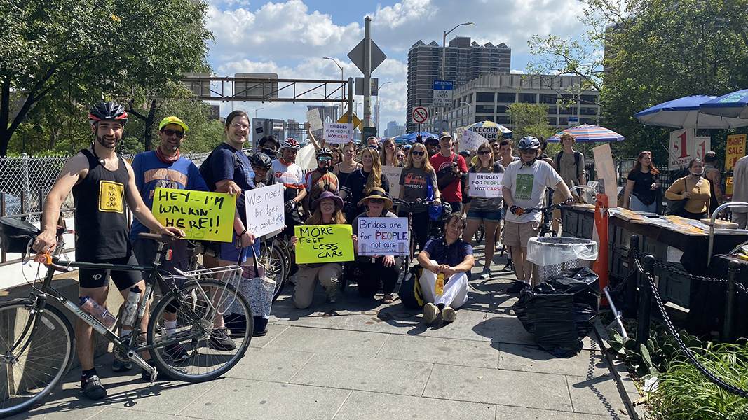 Our parade group holding signs at the entrance to to Brooklyn Bridge on the Manhattan