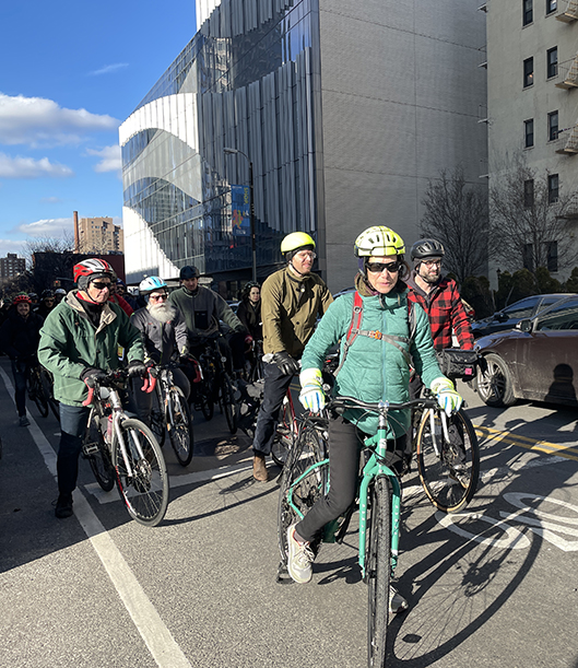 Bridges 4 People supporters ride down Ashland Place on a section where there is no protection, just a painted shared lane.