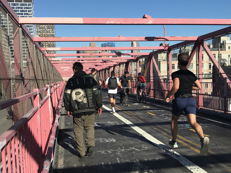 The
                Williamsburg Bridge's side by side bike and pedestrian
                spaces